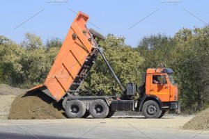 The dump truck unloads rubble the truck dumped the cargo sand and gravel